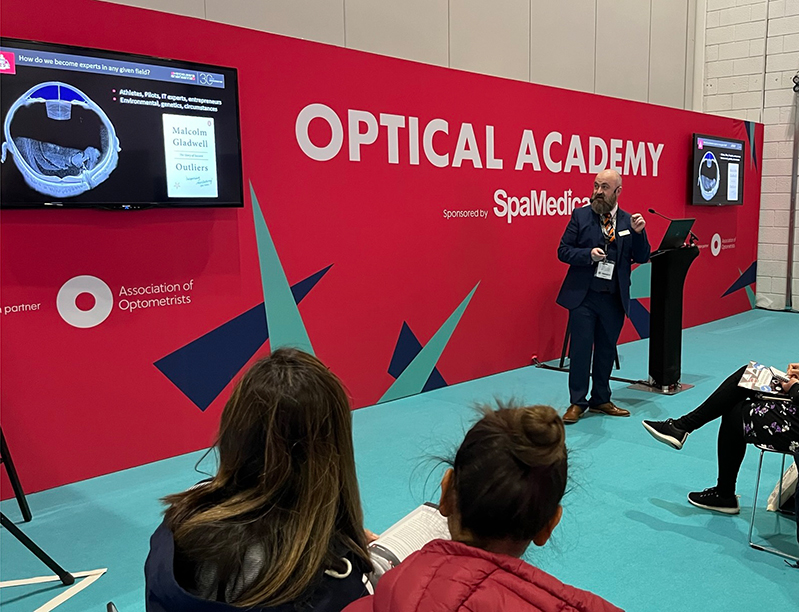 Tim Cole delivering a lecture at 100% Optical 2022